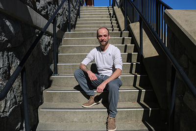 Scott Demeules sitting on some stairs at Bear Mountain in Victoria, BC.